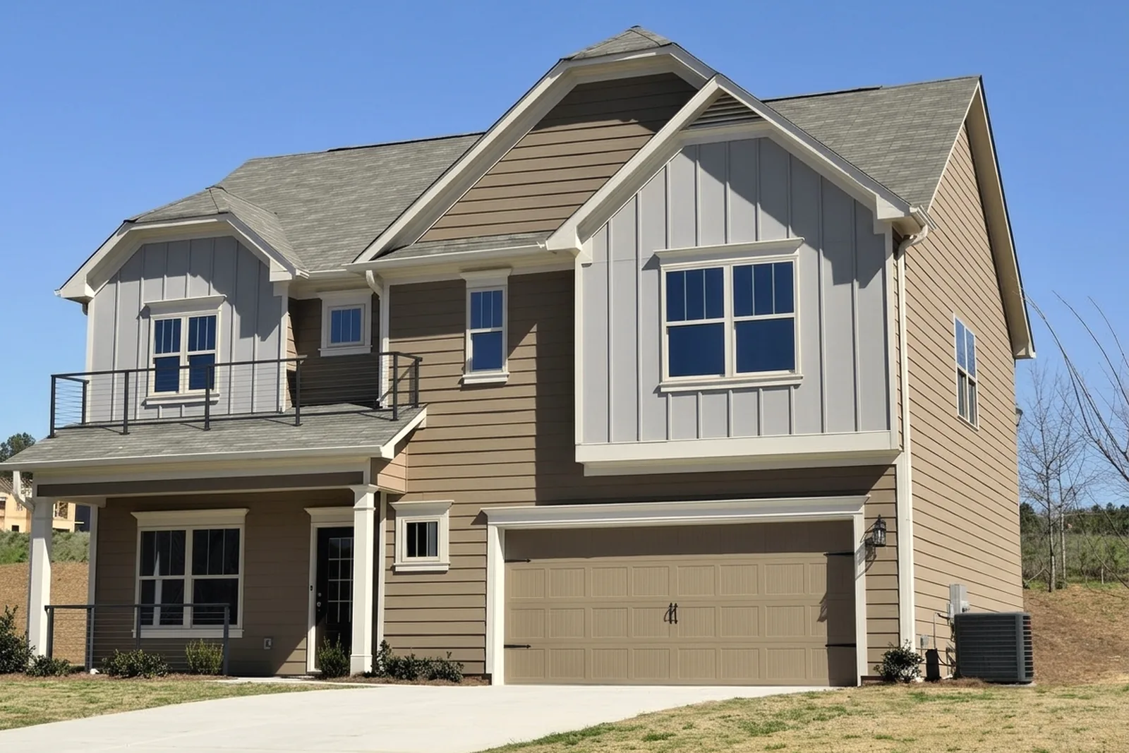 Newer two-story home with a dark metal balcony railing and side gate