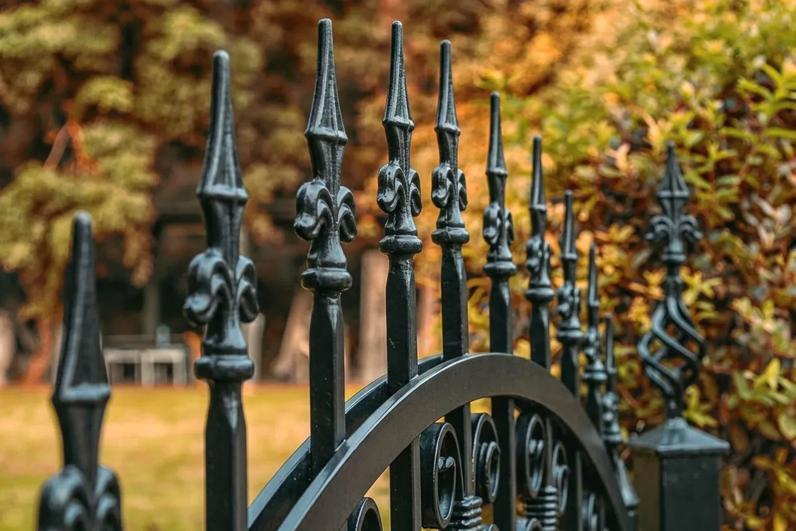 Ornate steel railing section next to a simple aluminum railing section