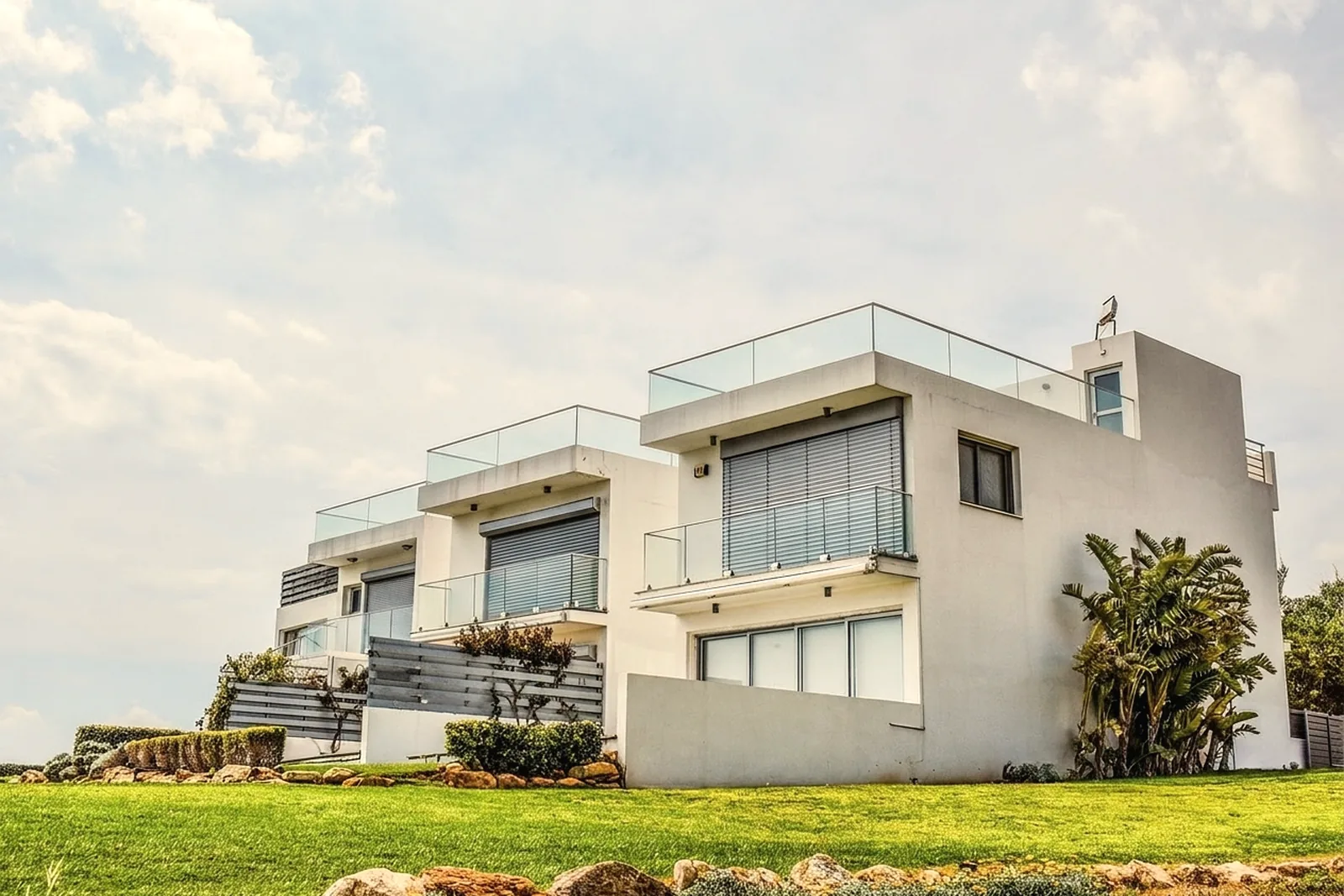 Balcony with frameless glass railing panels and a valley view